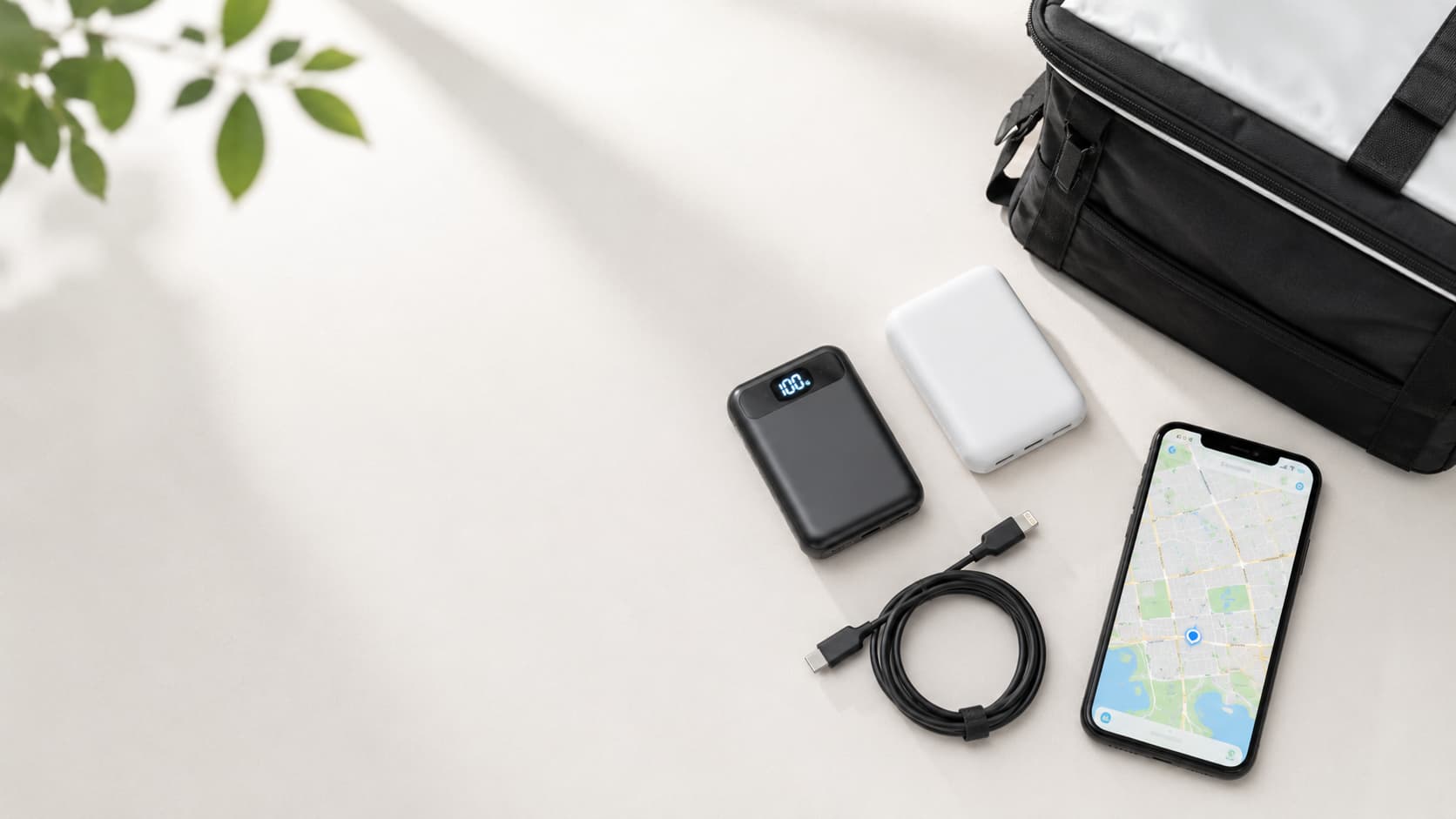 配達用のモバイルバッテリー2台と、地図を表示したスマホ、充電ケーブル、配達バッグを並べた写真